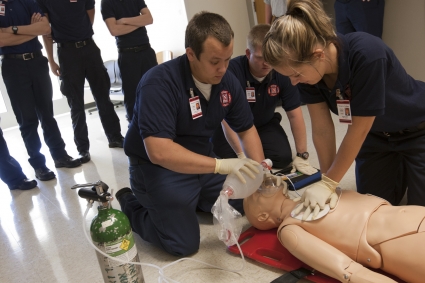 FR to EMR upgrade course students perform CPR on a cardiac arrest patient.