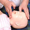 A student performs infant CPR in a Priority Care First Aid class.